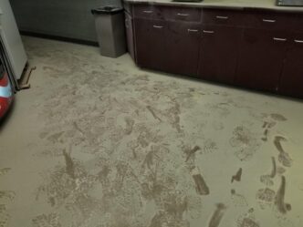 A trail of footprints in a kitchen area covered with fire extinguisher powder.