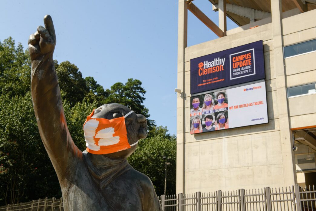 Tiger statue with mask in front of football complex