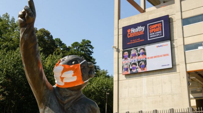 Tiger statue with mask in front of football complex