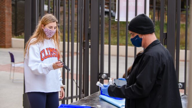 A student participates in COVID-19 testing at Memorial Stadium