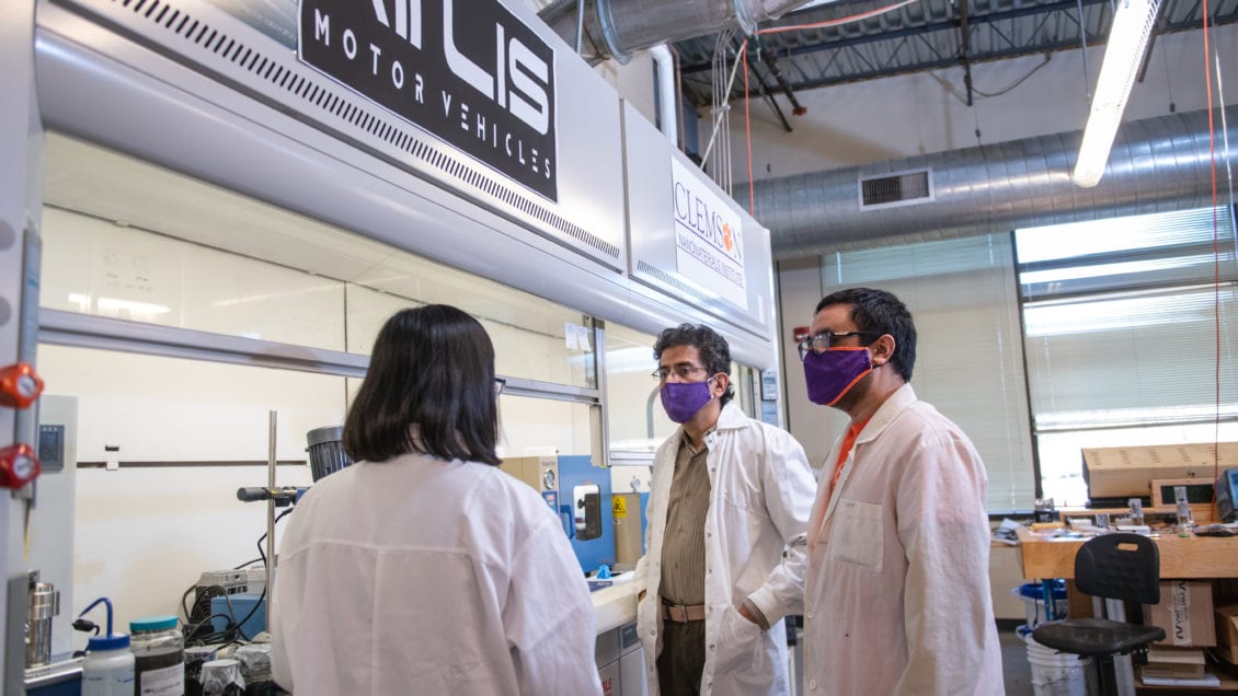 Apparao Rao, the R.A. Bowen professor of physics, speaks with two research team members at the Clemson Nanomaterials Institute.