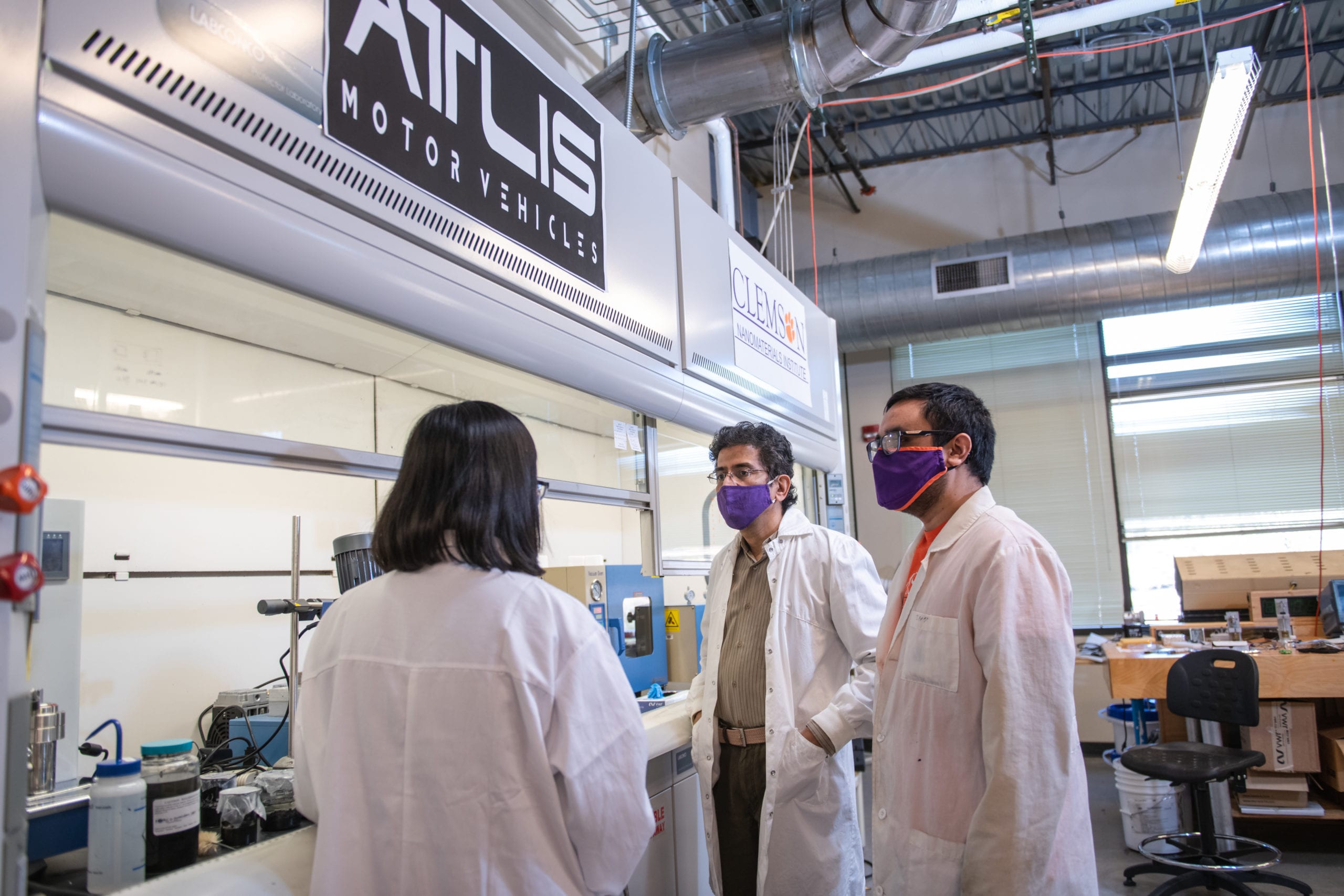 Apparao Rao, the R.A. Bowen professor of physics, speaks with two research team members at the Clemson Nanomaterials Institute.