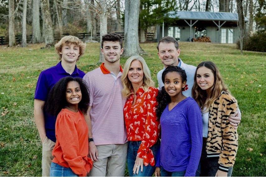 Image of the McWarteres with their five children outside.