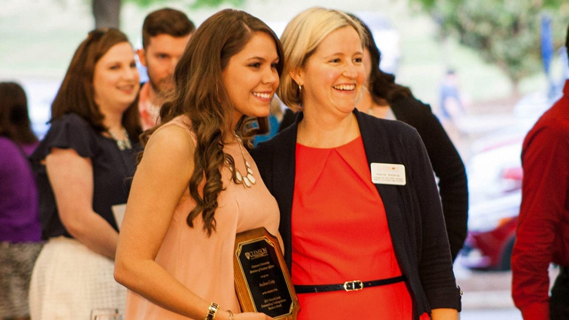Alanna Landreth poses for a picture with a student award winner at a Division of Student Affairs event in 2015