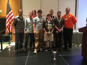 The CU Cyber team poses with its place trophy at the Palmetto Cyber Defense Competition. From left to right, front to back: John Hoyt, Spencer Provost, Peter Schatteman, Nick Bulischeck, Mackenzie Binns, Kevin McKenzie, Foster McLane, Tyler Bautista.