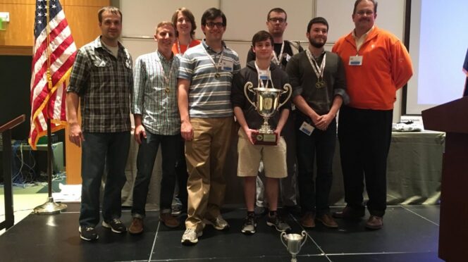 The CU Cyber team poses with its place trophy at the Palmetto Cyber Defense Competition. From left to right, front to back: John Hoyt, Spencer Provost, Peter Schatteman, Nick Bulischeck, Mackenzie Binns, Kevin McKenzie, Foster McLane, Tyler Bautista.