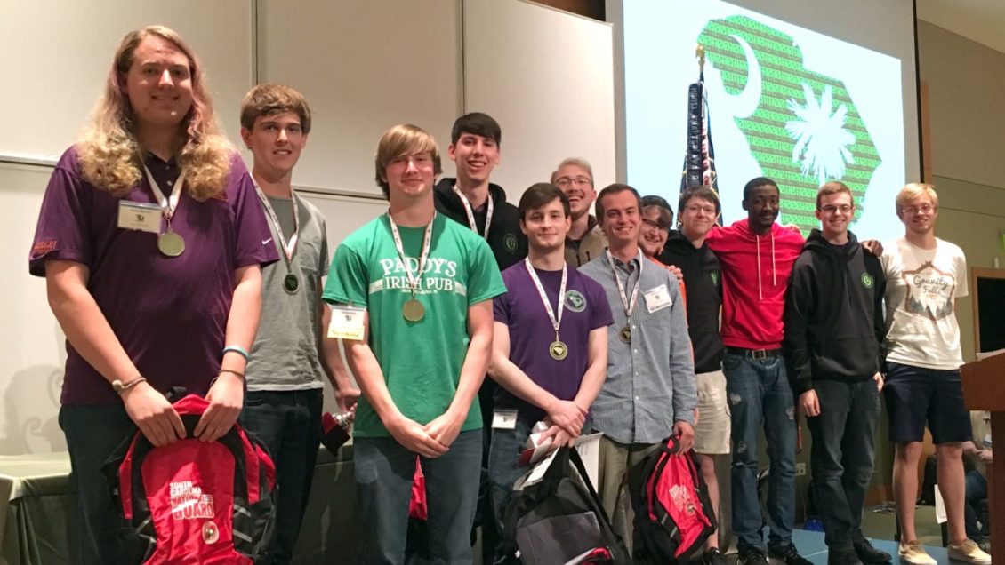 CU Cyber poses with its first-place medals at the Palmetto Cyber Defense Competition. From left to right: Foster McLane, Max Harley, Carson Sallis, Andrew Samuels, Nick Bulischeck, Rusty Cuff, Weston Belk, Nathan Gantt, Kyle Wolfe, Kenneth Simpson, David Houston, Zac Whitworth.