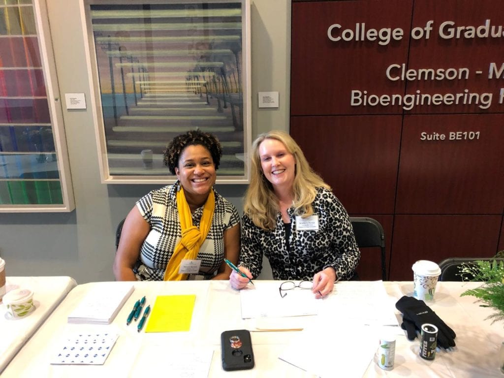 Malerie Hartsell (left) sits with fellow support group leader Kimberly Parker at the registration table at the South Carolina Chapter Scleroderma Patient Education Conference in 2020, before the pandemic. 