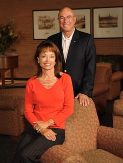 Portrait of Candi and Gerald Glenn in a home office.