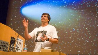 man standing at podium with stars in the background