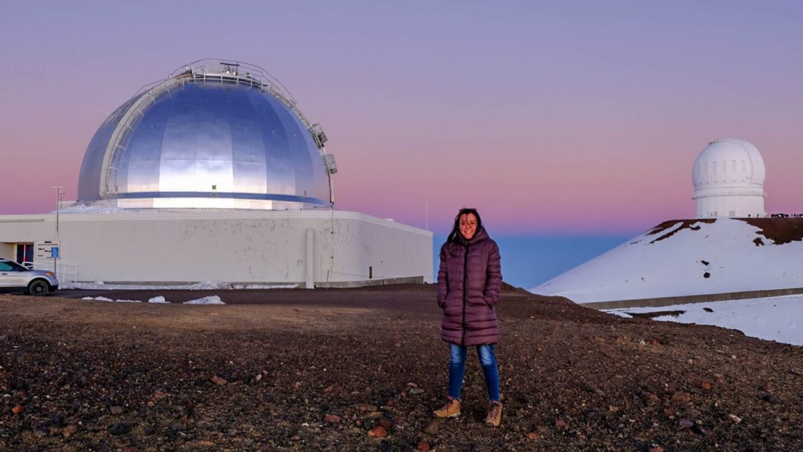 Lea Marcotulli standing in front of telescopes in Hawaii