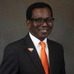 Man in business suit with an orange tie.