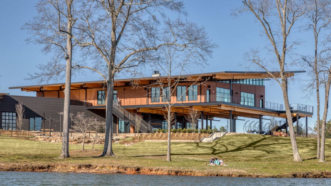 Outdoor view of the rear elevation of the Andy Quattlebaum Outdoor Education Center with the Lake Hartwell shoreline in front of it.
