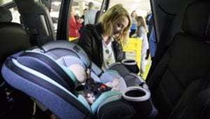 MTSA student Bridgette Watson, a child passenger safety program coordinator at Prisma Health-Upstate in Greenville, South Carolina, demonstrating how to install a child safety seat. This relates to road safety or transportation safety for children.