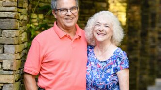 Debbie and Vince Jackson stand side-by-side smiling towards the camera.