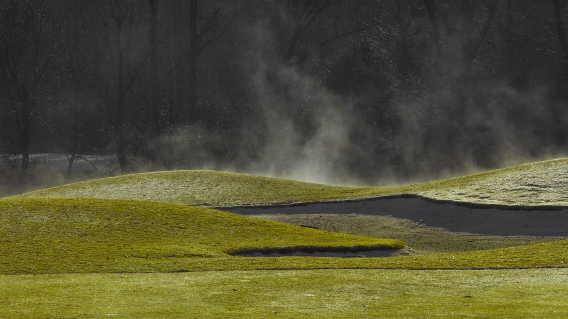Morning mist rising off golf course.