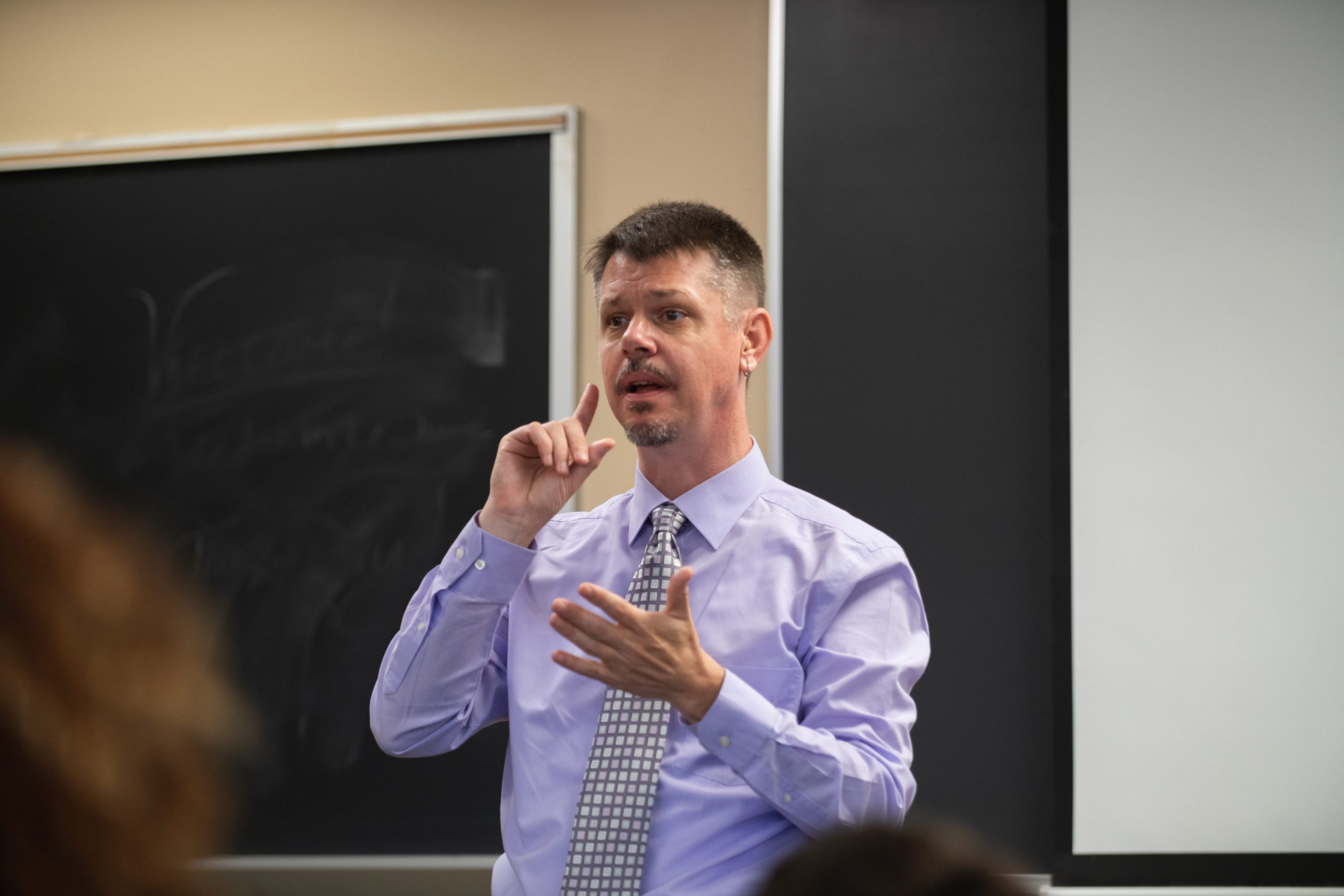 Professor communicates using American Sign Language in a classroom