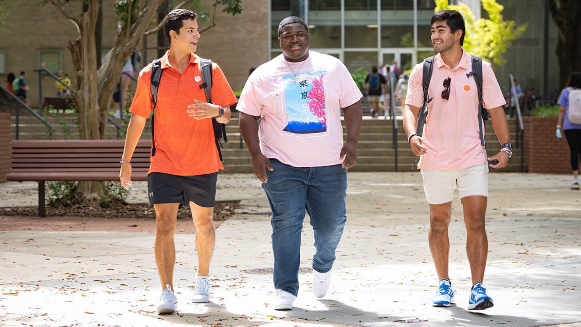 Three students walking together on campus