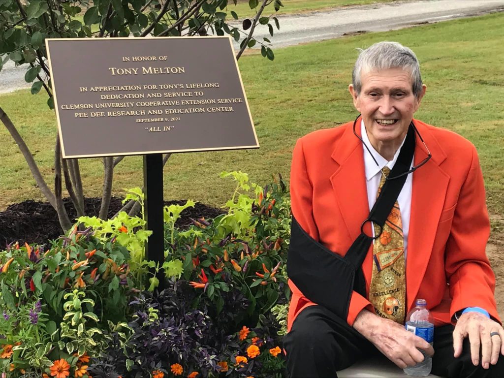 Tony Melton with the plaque presented and tree planted for his distinguished career with the Clemson extension service. The tree and flowers are in Tony’s Garden at the entrance to the Pee Dee REC.