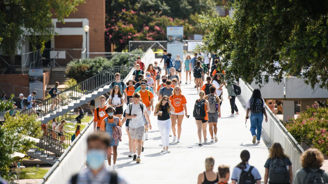 Students and staff navigate the Cooper Library bridge on main campus in August 2021