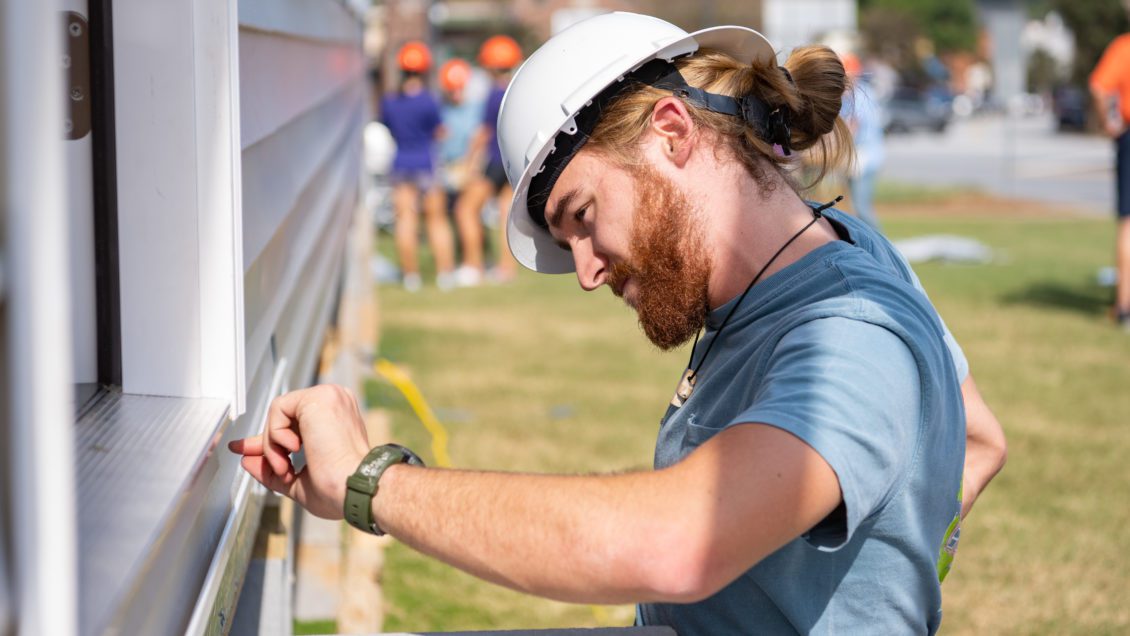 Matthew Grant, senior construction science and management major, works on the Habitat for Humanity build on Bowman Field