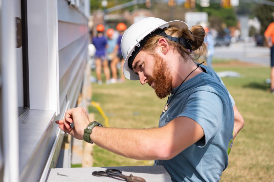 Matthew Grant, senior construction science and management major, works on the Habitat for Humanity build on Bowman Field