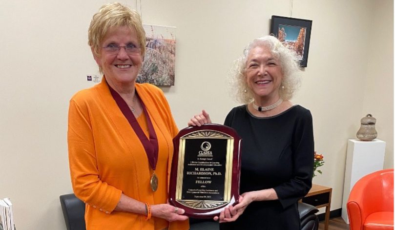 Emeritus College Director Debra Jackson (right) presents a plaque to Elaine Richardson.