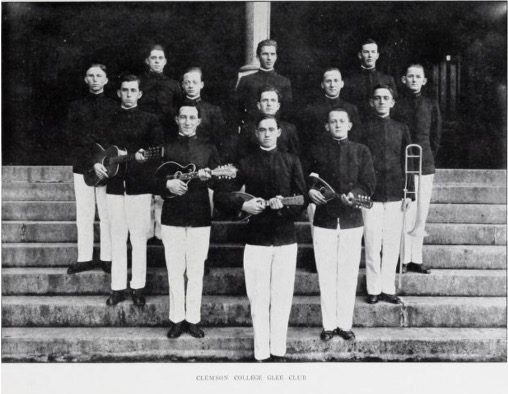 uniformed students holding musical instruments
