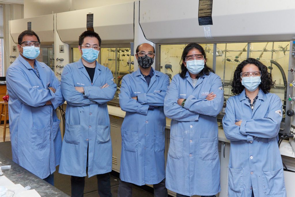 a group of scientists posing in a lab