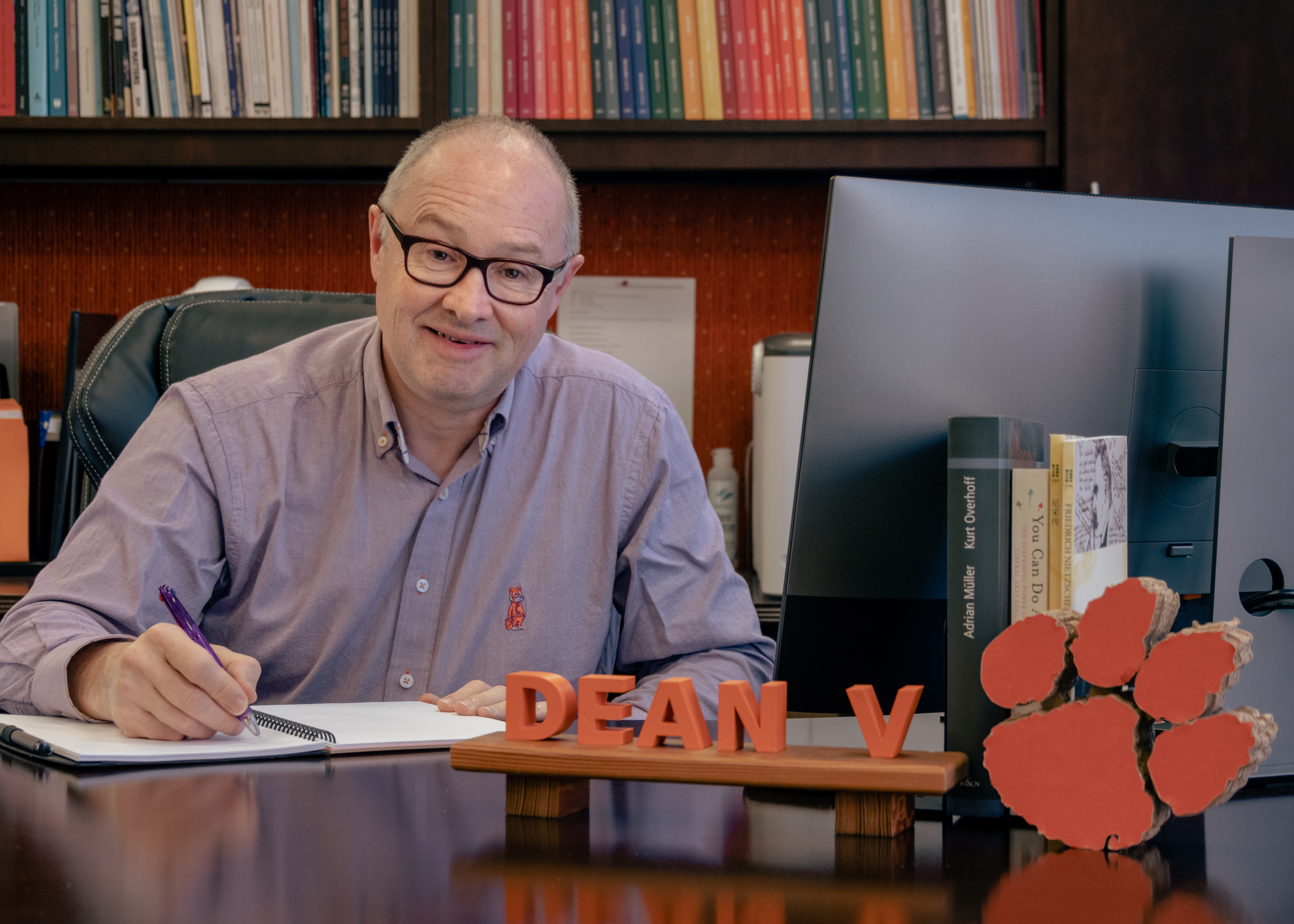 Dean Vazsonyi at desk writing