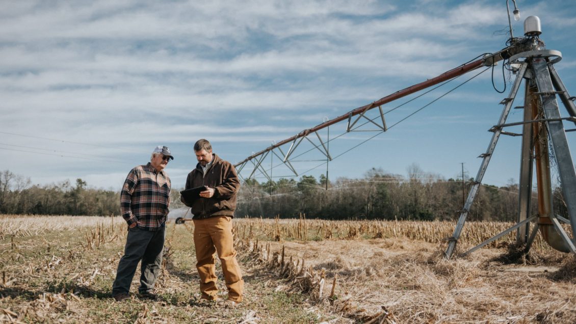 Bamberg County farmer Richard Rentz (left) and precision agriculture engineer Kendall Kirk stand together working with irrigation technology.