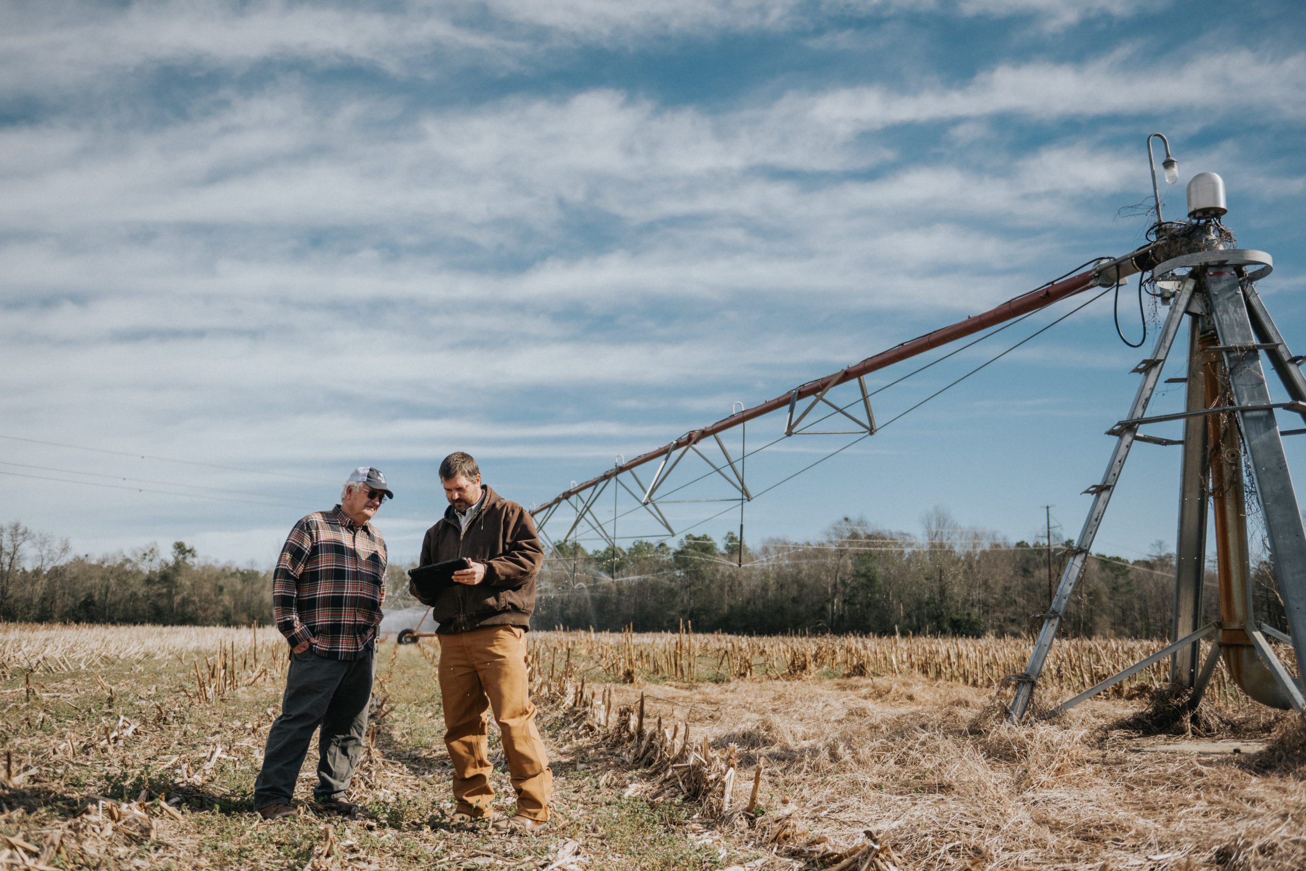 Bamberg County farmer Richard Rentz (left) and precision agriculture engineer Kendall Kirk stand together working with irrigation technology.