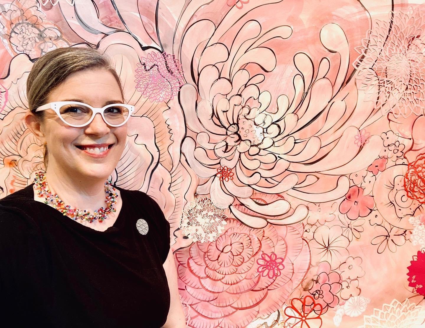Image of Valerie Zimany in front of pink artwork