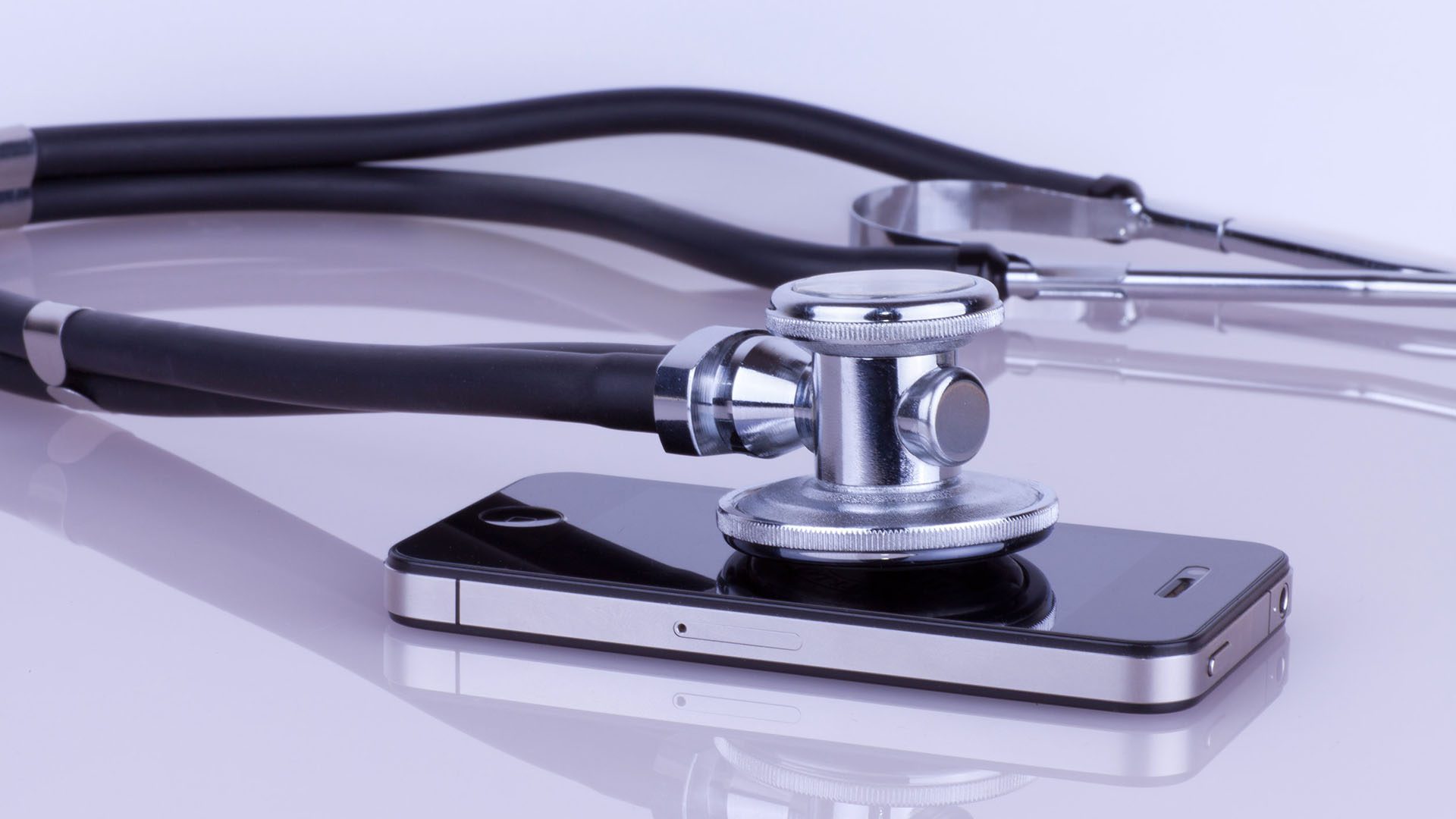 stethoscope lying on a cell phone