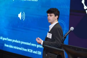 Jack Carson, a junior genetics major, stands in front of a blue screen during his presentation at the College of Science's Catalyst Competition