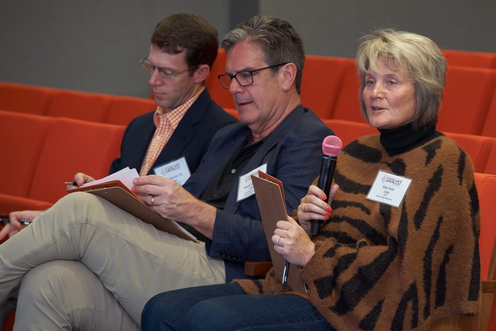 Amy Yoder, one of the judges for the College of Science's Catalyst Competition, asks a question after one of the student teams presented their idea, while judges Jeff Pearson (left) and Woody Bryan (middle) look on.