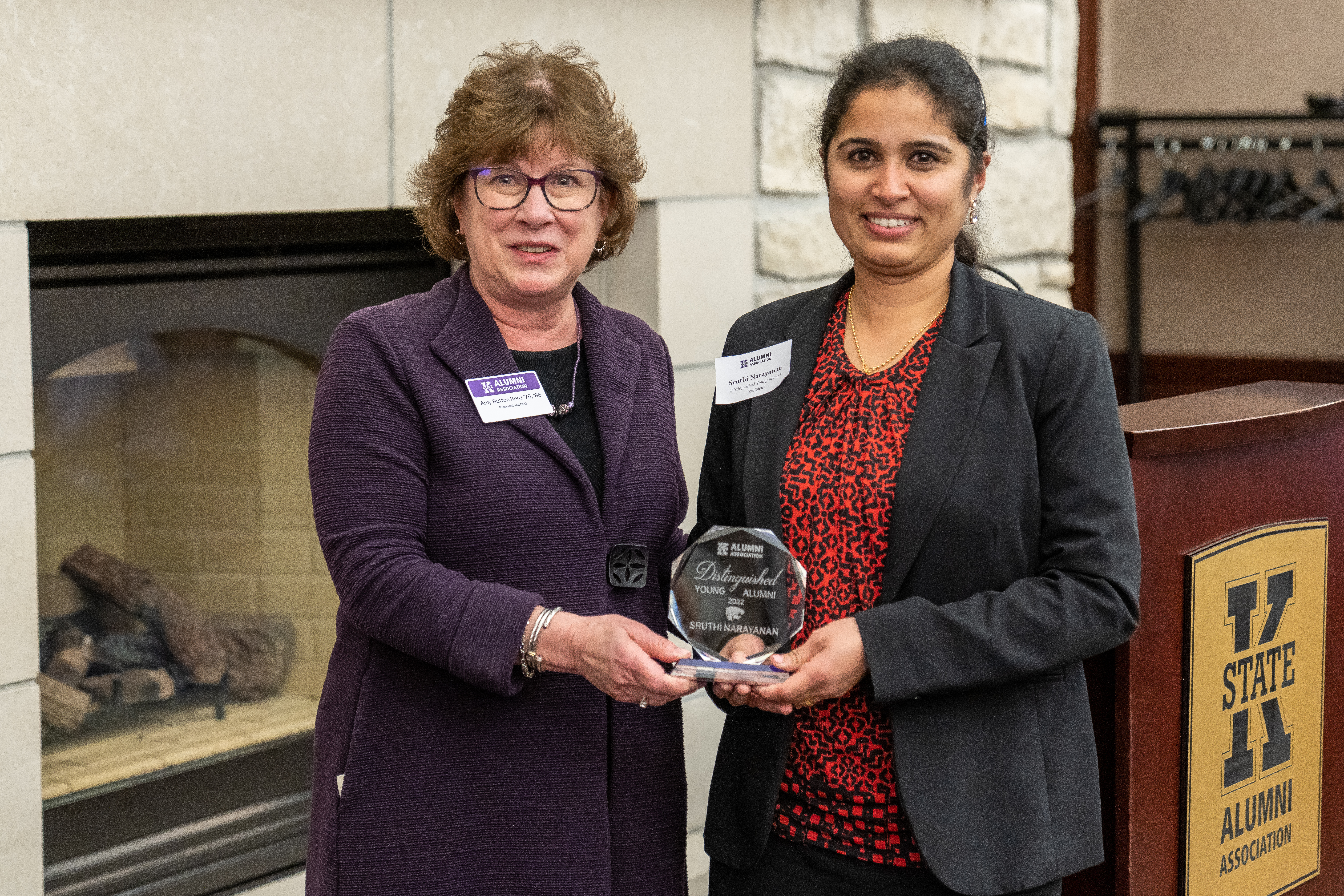 Amy Button Renz, president and CEO of the Kansas State University alumni association, presents Sruthi Narayanan, a Clemson assistant professor of crop physiology, with the university's 2022 Distinguished Young Alumni Award.