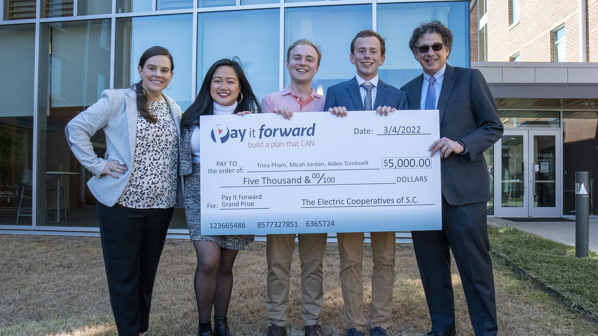 Elizabeth Edwards Martin with Blue Ridge Electric Cooperative presenting the competition award check to Clemson students Trina Pham, Micah Jordan and Aiden Tombuelt, with William Lasser from the Clemson University Honors College.