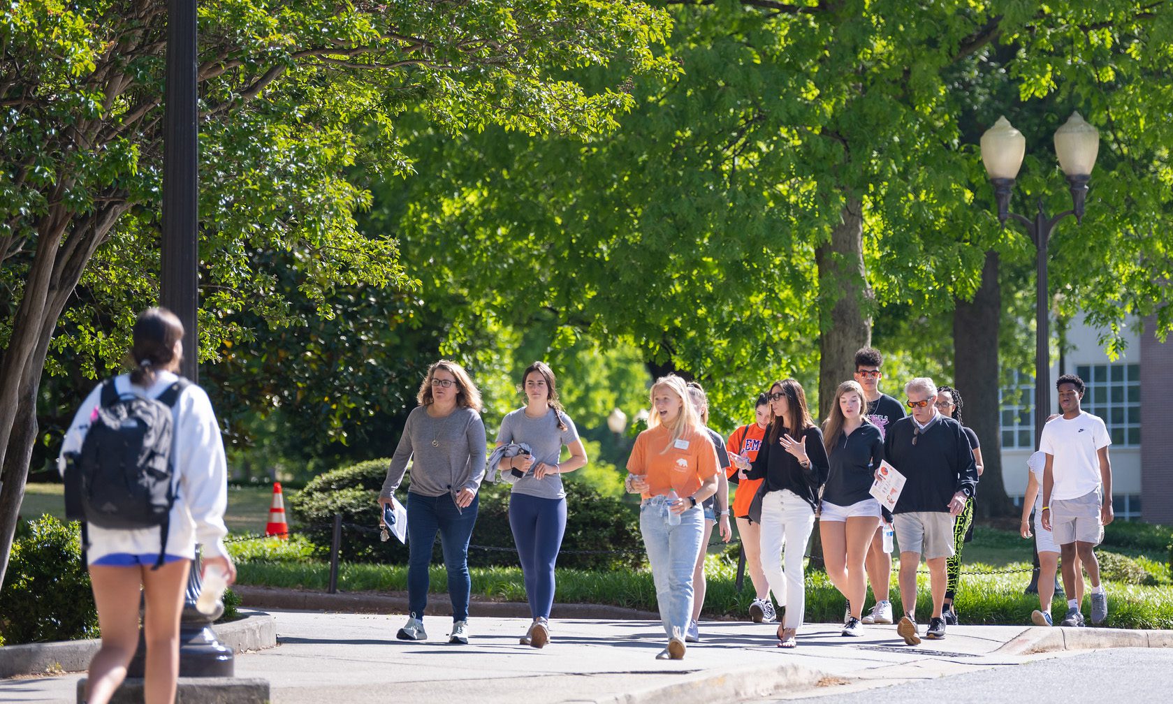 Students walking outside, speaking with one another as they walk. Spring 2022 dean's list
