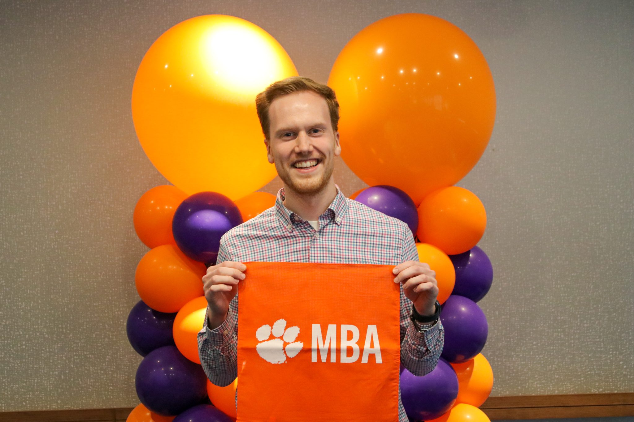 Josh Malzahn holding MBA tiger rag