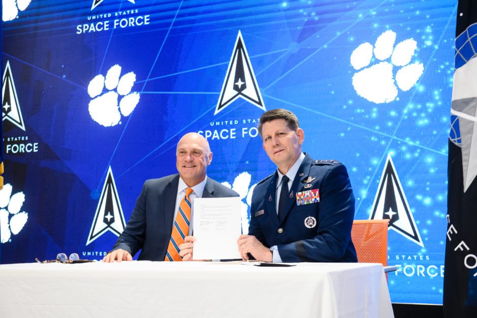 Clemson University President and Vice Chief of Space Operations Gen. David D. Thompson hold up the signed Memorandum of Understanding.
