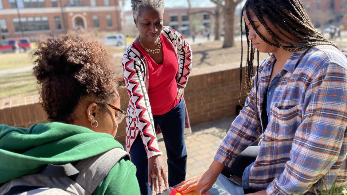 L. Kaifa Roland, director of Clemson's Global Black Studies Program, speaks with two students outside Sirrine Hall.