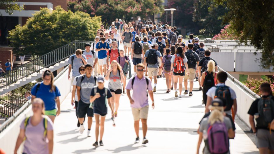 Students walking library bridge on campus