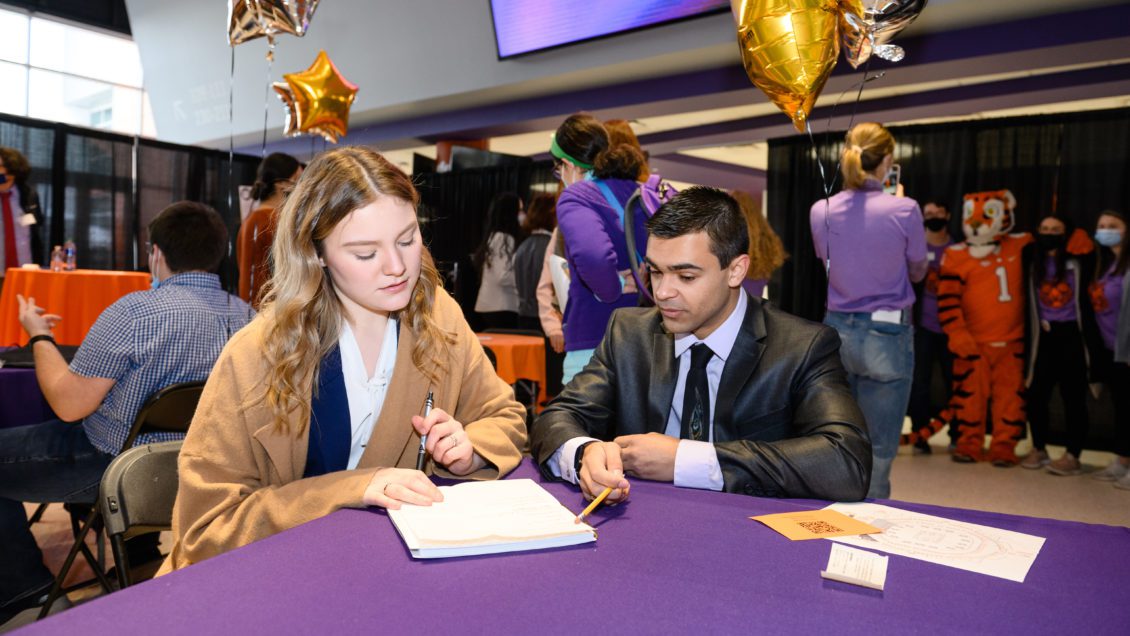 Students review resumes during the Career Fair