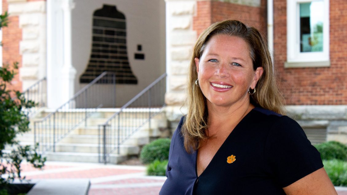 Brooke Whitworth, associate professor in the College of Education, standing in front of a brick building on Clemson University's campus.