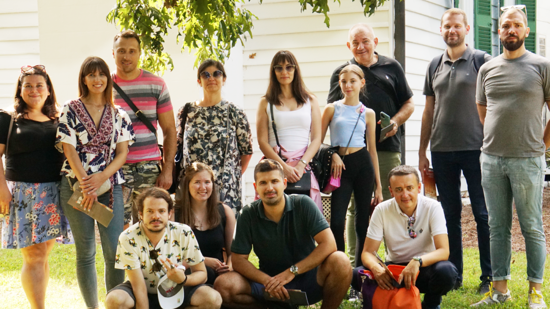 Members of the exchange group from the University of Belgrade poses in front of a building on Clemson University's campus.