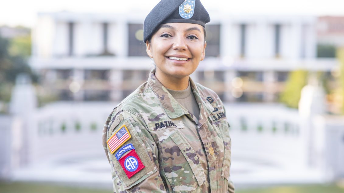 A woman wearing a U.S. Army uniform poses in front of the amphitheater at Clemson University.