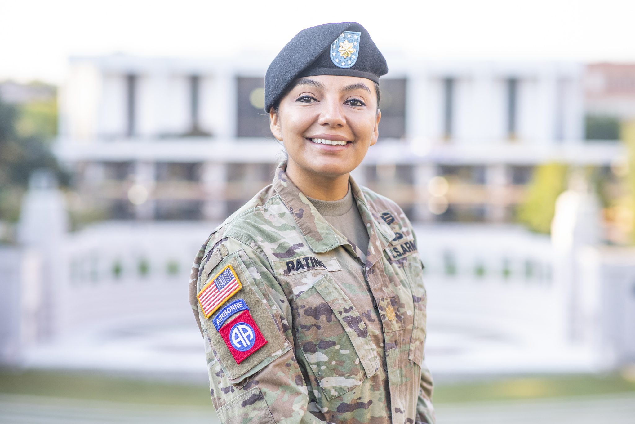 A woman wearing a U.S. Army uniform poses in front of the amphitheater at Clemson University.