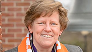 A headshot of Clemson Professor of Psychology June Pilcher in front of a brick building on campus.