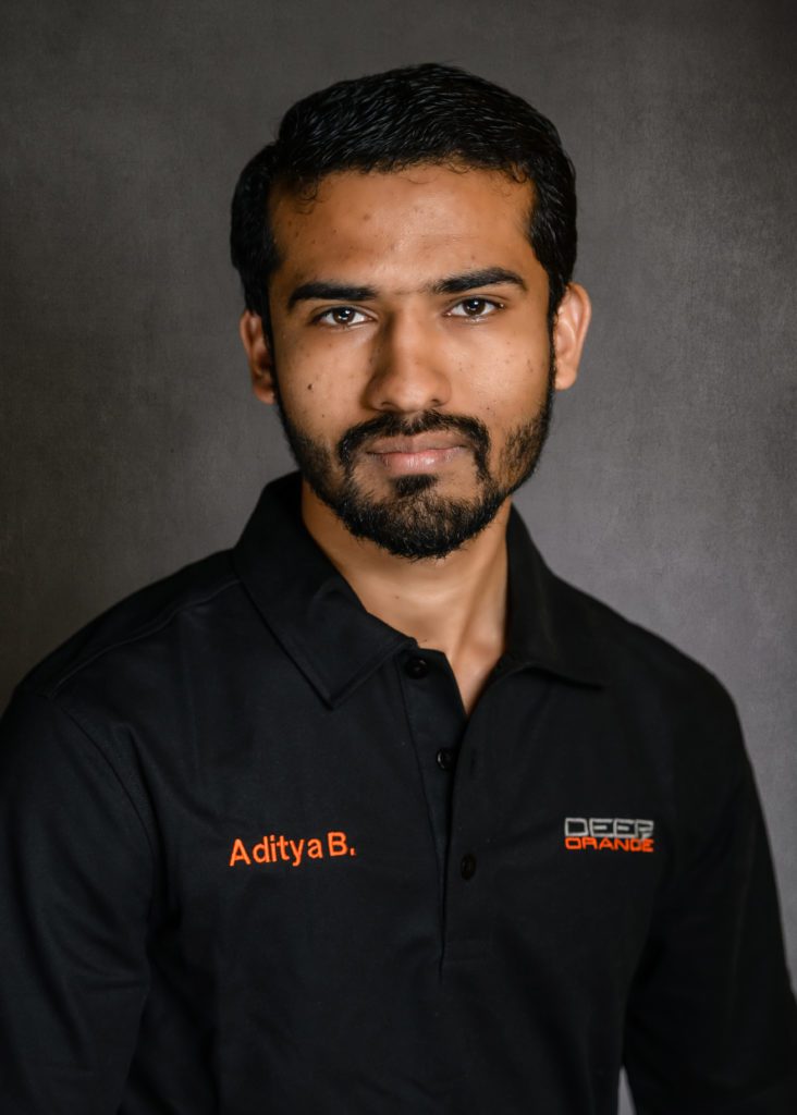 headshot of Deep Orange 11 student Aditya Bhagat wearing a black short-sleeve polo shirt.